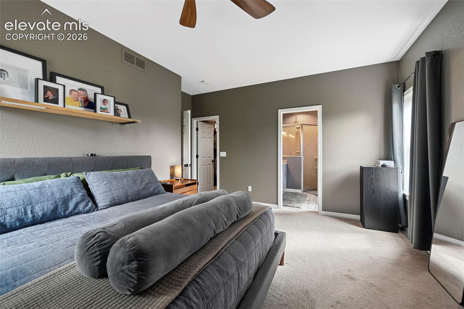 Spacious room featuring carpeted flooring, a ceiling fan, and a neutral wall color