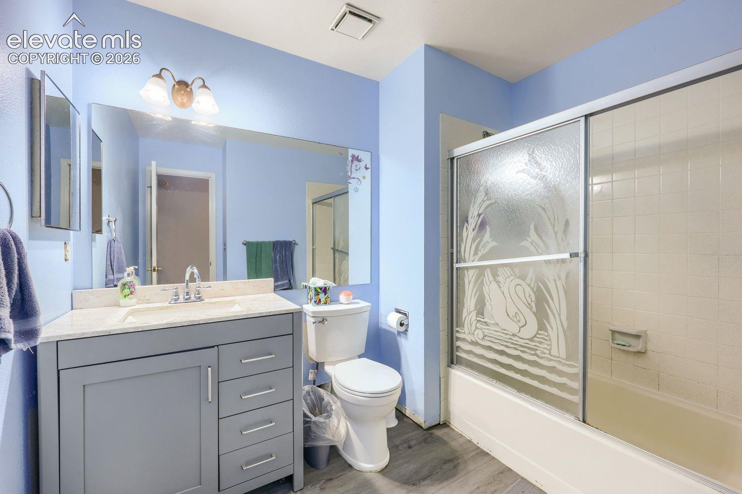 Vanity with stone-finish countertop, single basin sink, and chrome faucet