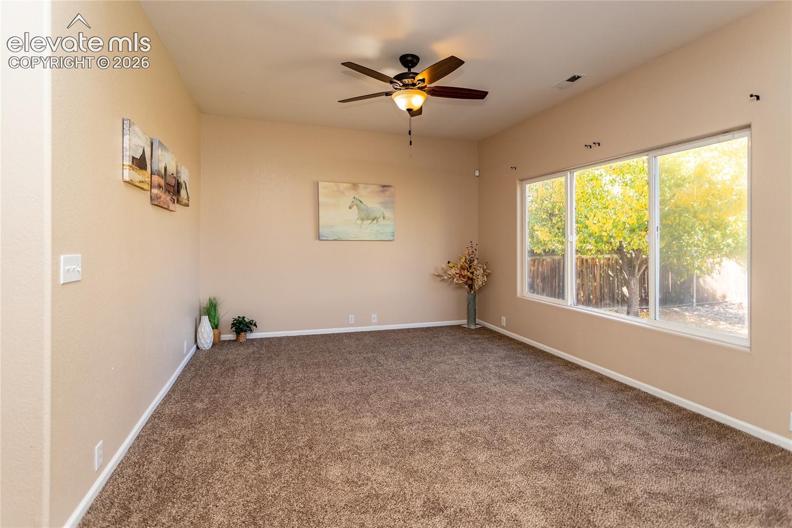 The lower-level walk-out family room provides a light-filled setting for relaxation or movie nights