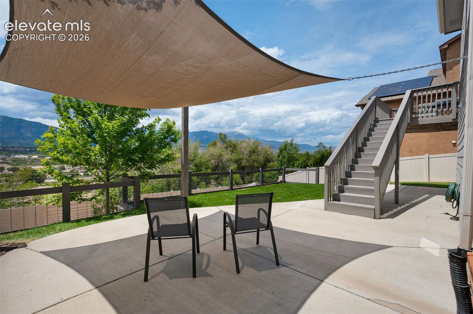 Outdoor patio area featuring a shade sail and concrete surface