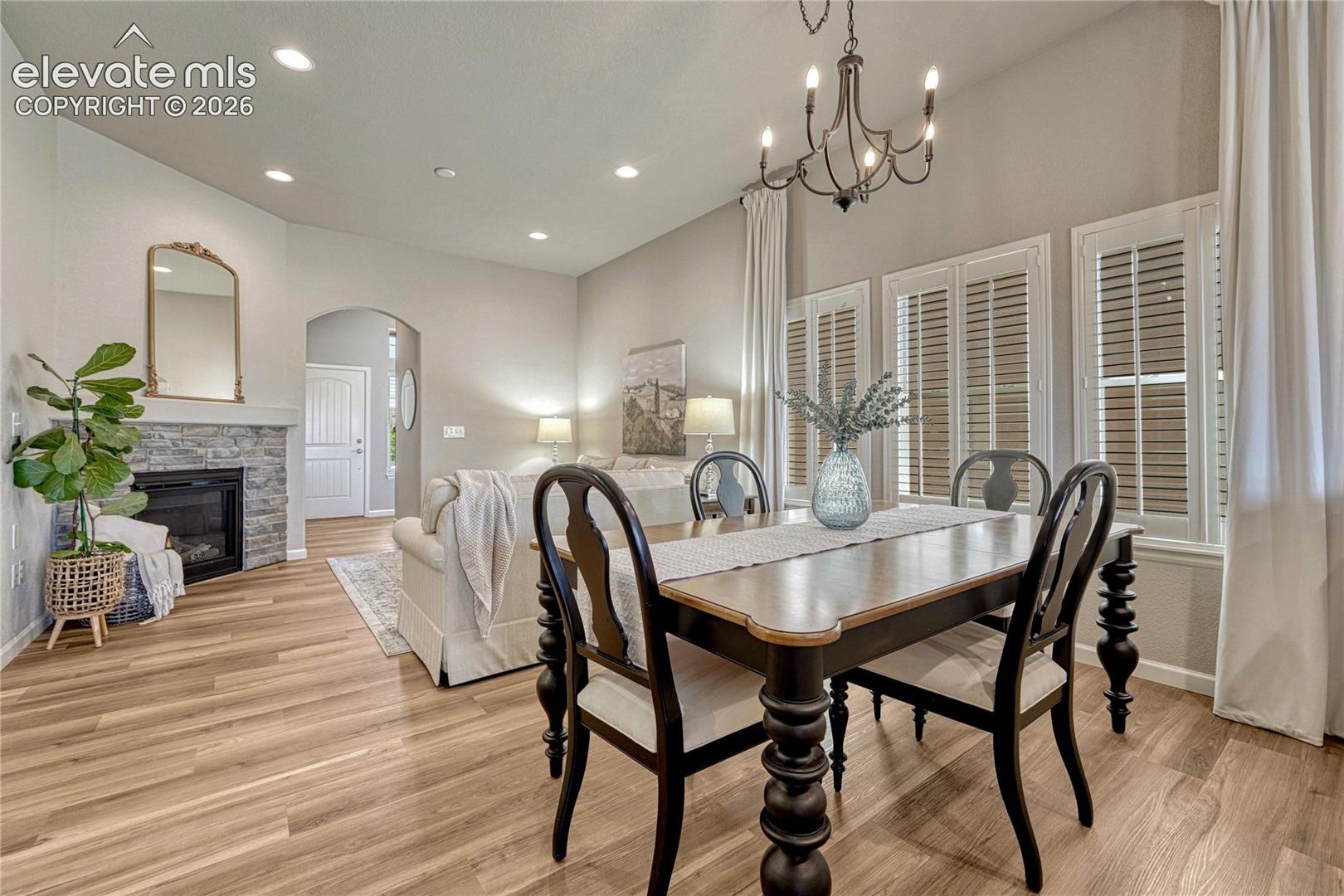 Enjoy effortless entertaining in this connected living and dining space highlighted by elegant plantation shutters.
