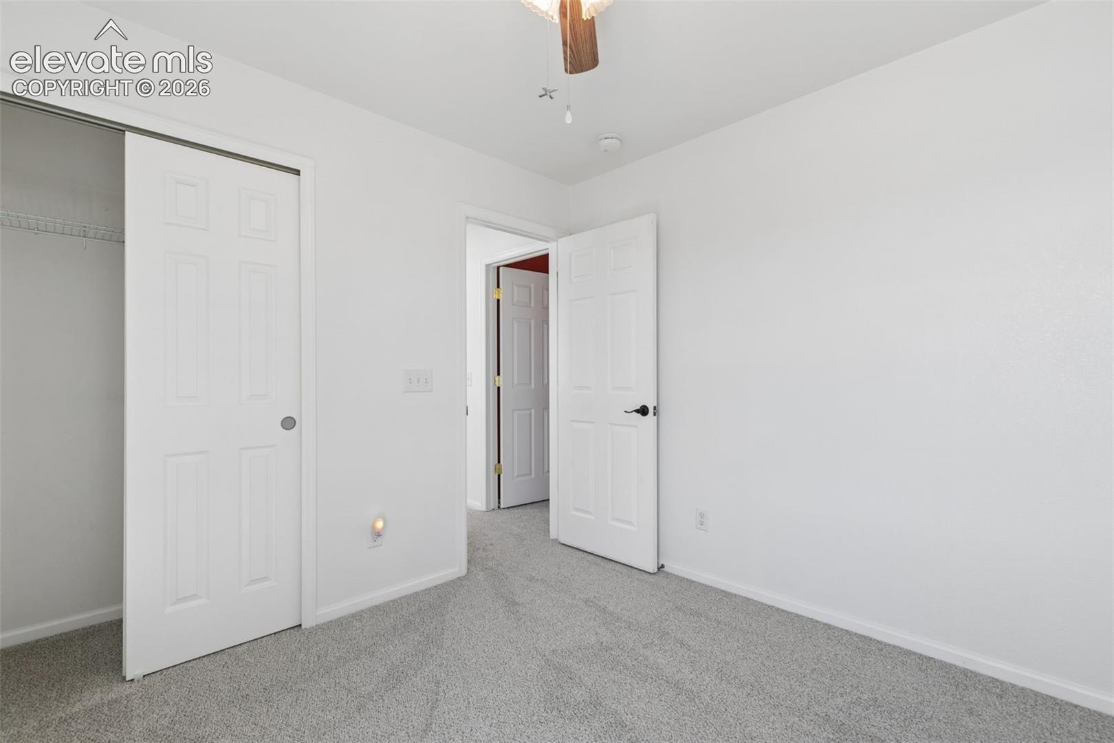 Soft gray carpet flooring and white painted walls