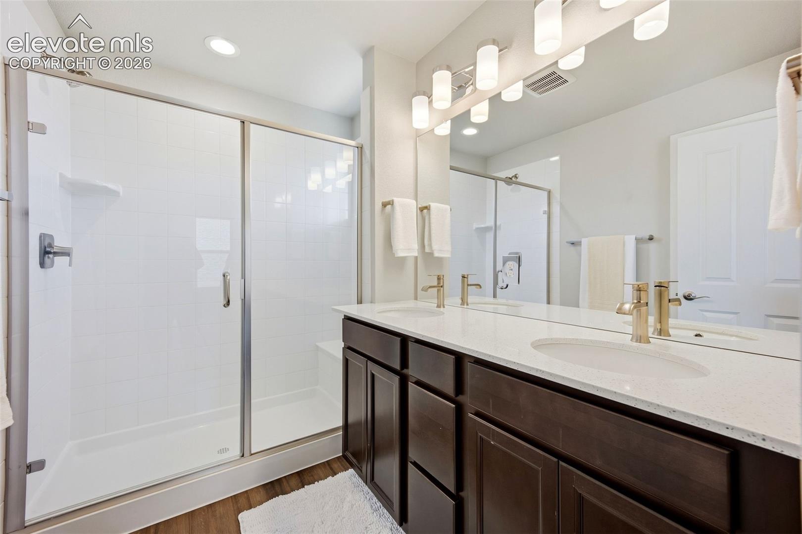 Primary bath with walk in spa shower and double vanity