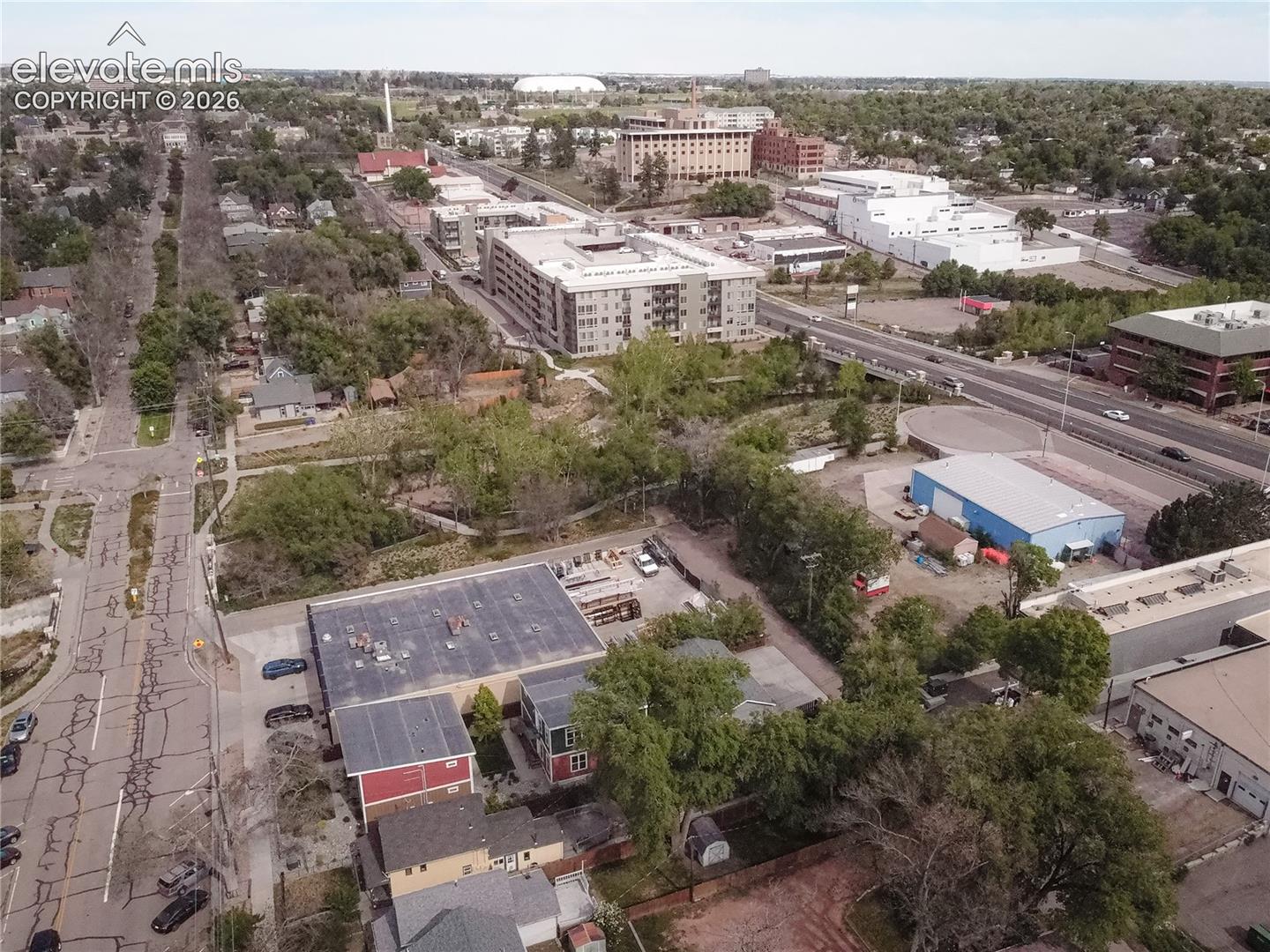 Aerial perspective showcasing a mixed-use urban landscape with commercial and residential structures