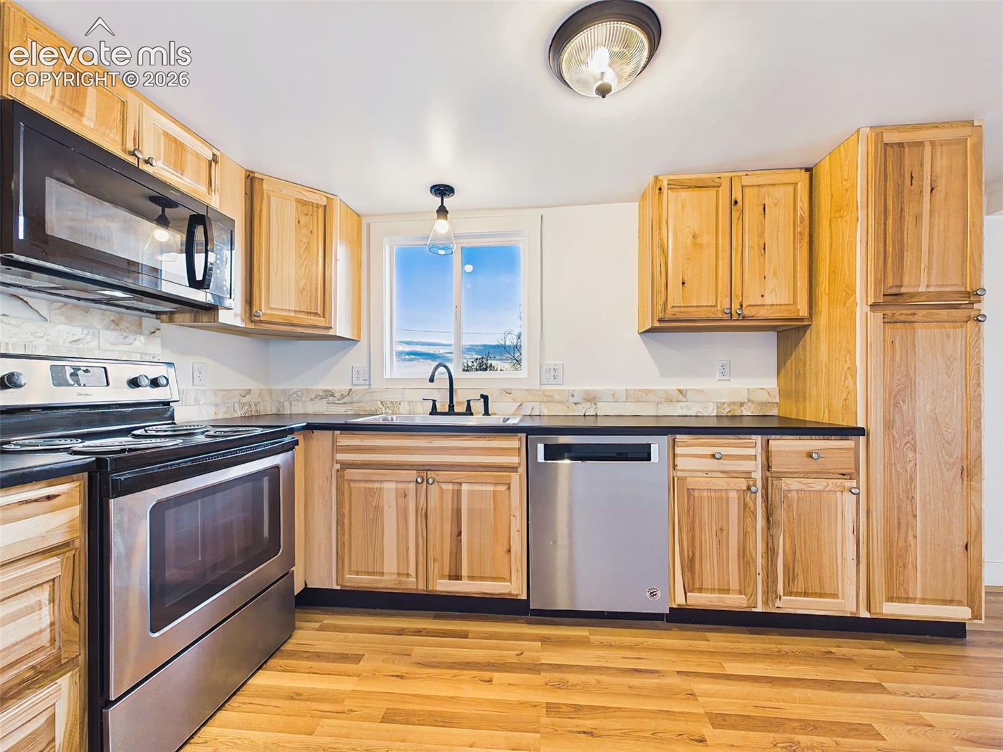 Kitchen – Modern all-electric kitchen offers generous workspace, abundant cabinetry, and an efficient layout for everyday cooking.