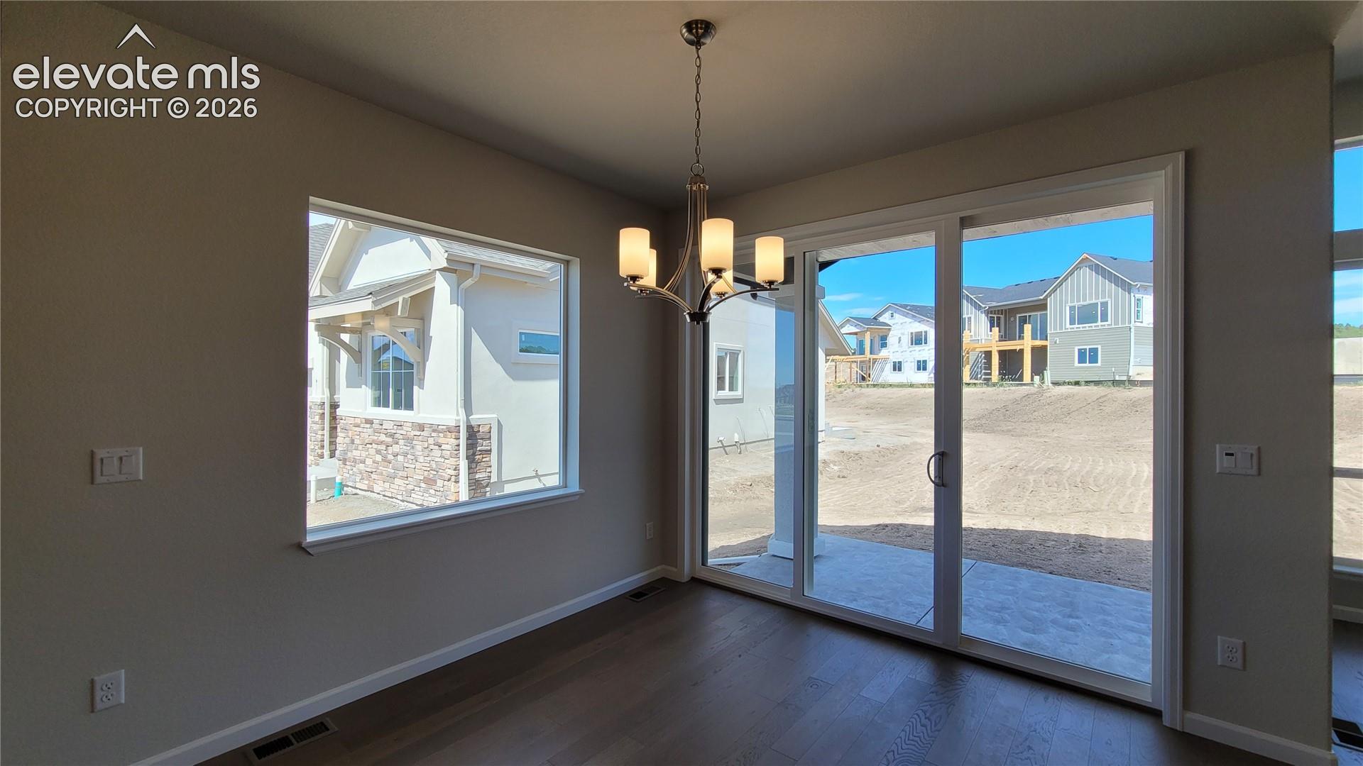 Dining area with engineered wood flooring, abundance of natural light, and walks out to covered patio! 
