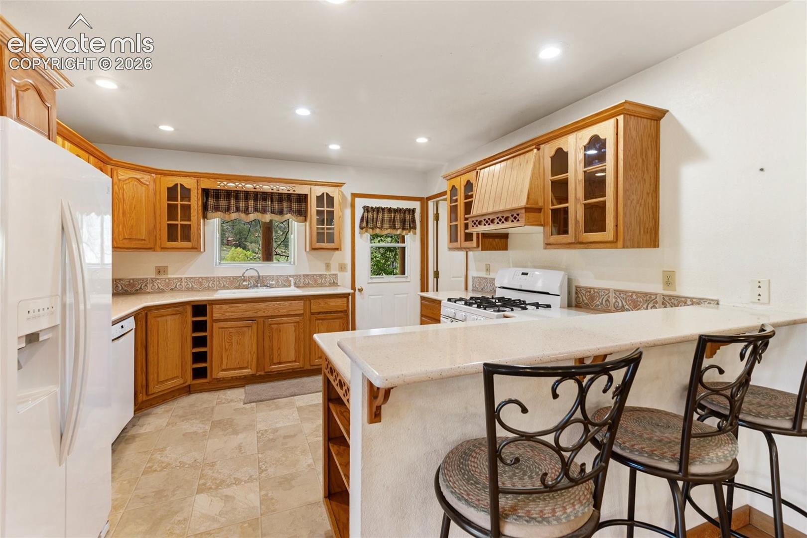 Kitchen with quartz counter tops and gas stove.