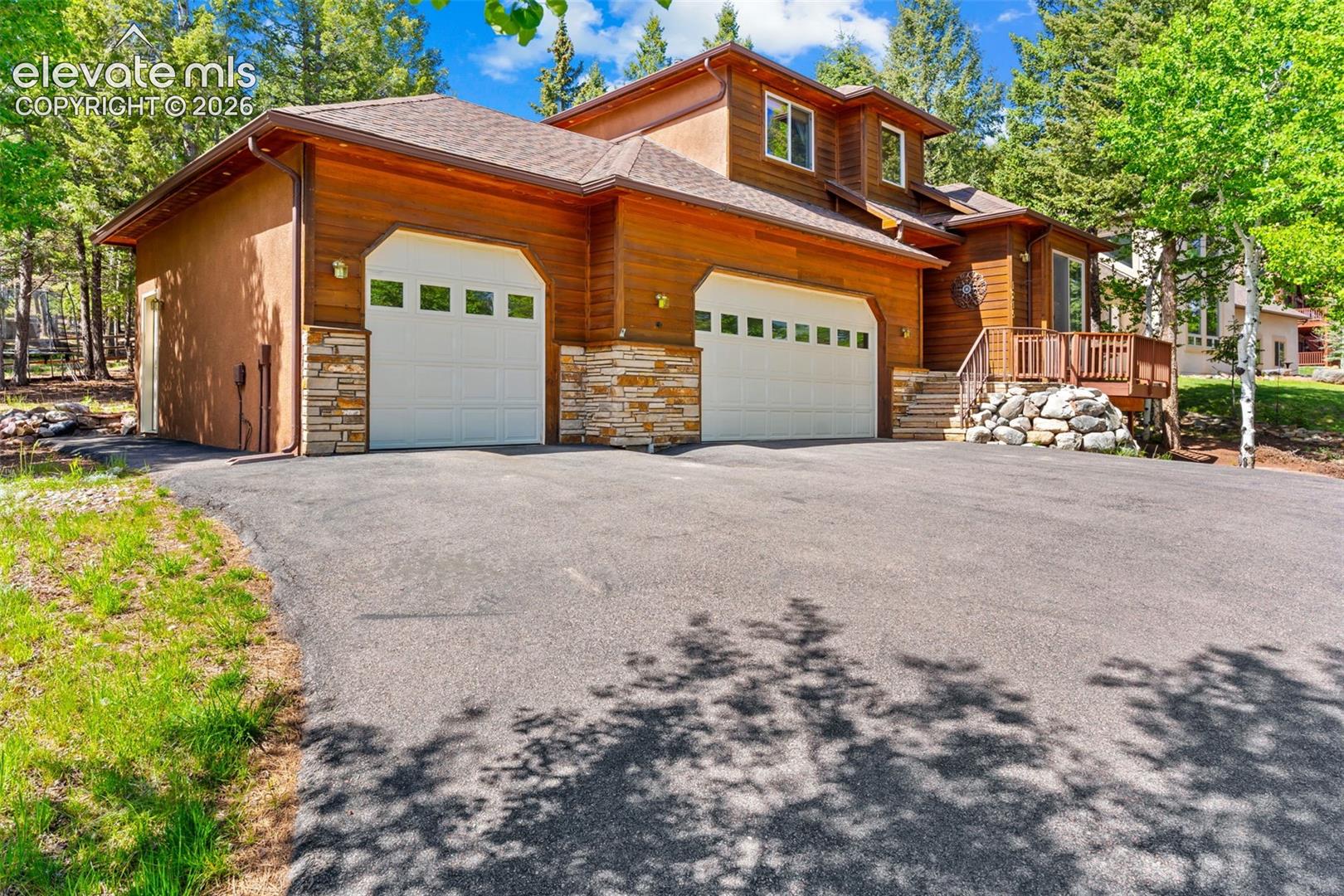 **Beautifully maintained 2-story home featuring 6 bedrooms, 4 bathrooms, and a 3-car garage on a spacious 0.35-acre cul-de-sac lot.** This bright, move-in-ready home offers hickory flooring throughout much of the main level, a sunken living room with access to a private deck, formal dining room, and a well-appointed kitchen with hickory cabinetry, granite tile countertops, stainless steel appliances, pantry, and breakfast nook that opens to the backyard patio. The inviting sunken family room features a gas fireplace and built-in bookshelves, while a main-level bedroom, full bath, and laundry room add everyday convenience.Upstairs, the spacious primary suite boasts French doors, a gas fireplace, a luxurious 5-piece ensuite bath, and a walk-in closet. Two additional bedrooms and a full hall bath complete the upper level. The permitted, fully finished basement is designed for entertaining, featuring a large wet bar with dining area, spacious family room, **dedicated theater room with projector and surround sound wiring**, two additional bedrooms with walk-in closets, and a full bath.The insulated and finished 3-car garage offers abundant storage, including built-in shelving and an oversized third bay. Outside, enjoy a private fenced backyard with a patio and play area complete with a trampoline, play structure, tire swing, and sandbox. Ideally located just minutes from shopping, dining, parks, and the recreation center, this exceptional home offers the perfect blend of space, comfort, and convenience.
