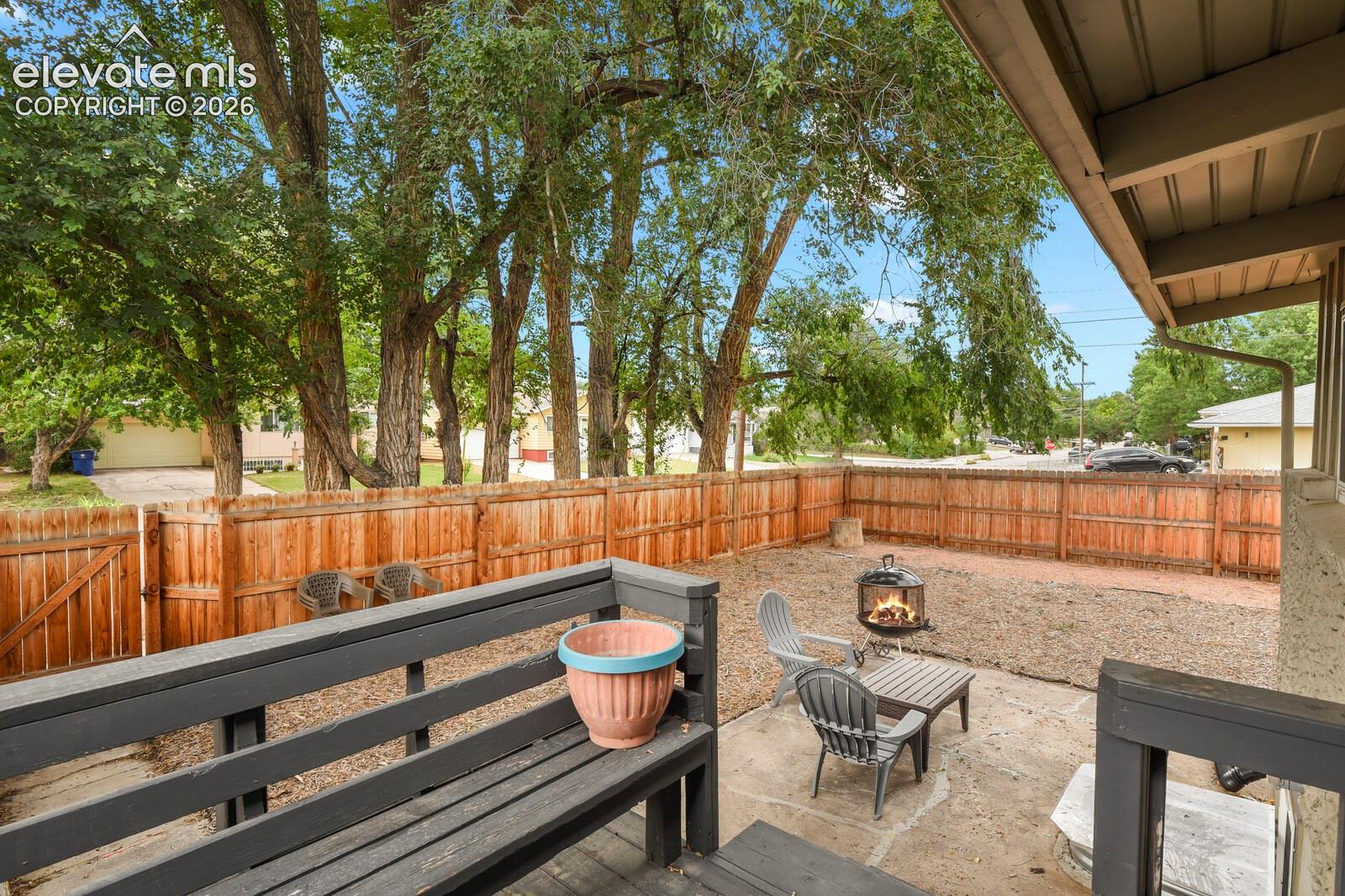 Shot of the patio and backyard from the porch off the kitchen door.