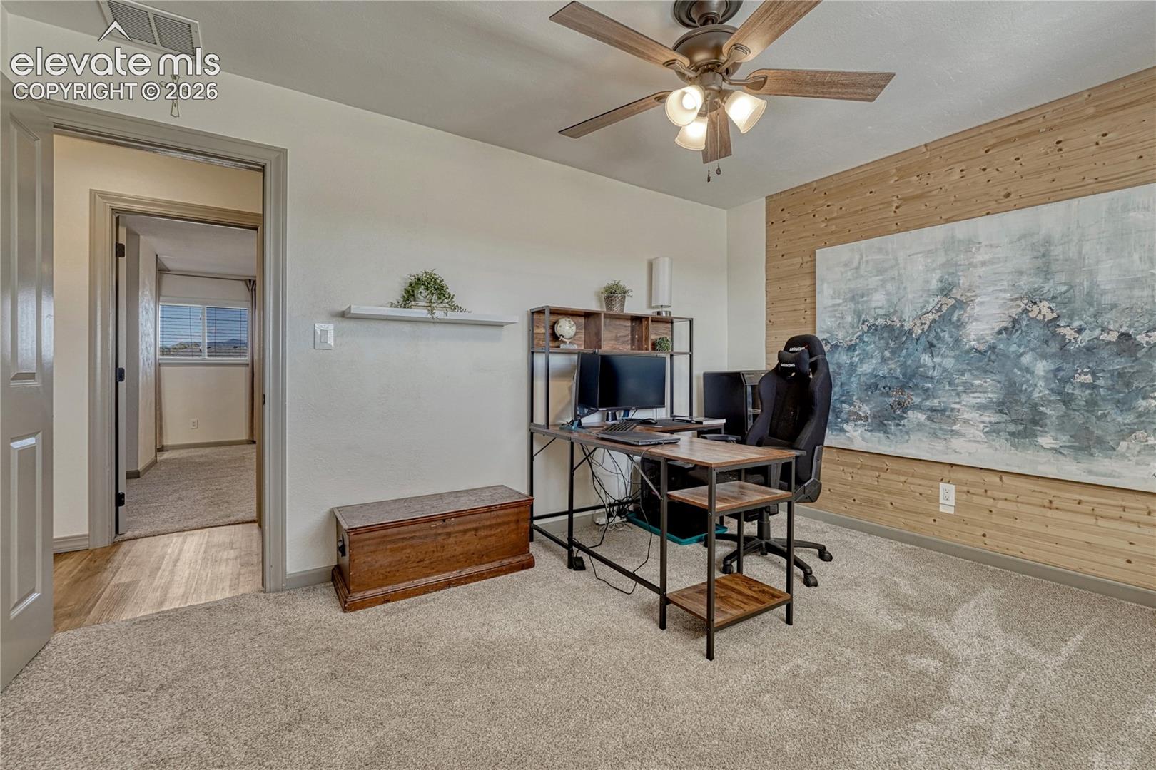 Main level bedroom with wood accent wall
