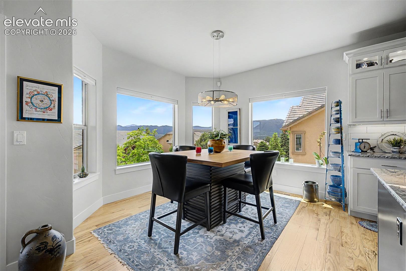 Though shown with a 4-seat dining table, this area is definitely large enough to accommodate a 6 person or even larger table. Don't forget the views!