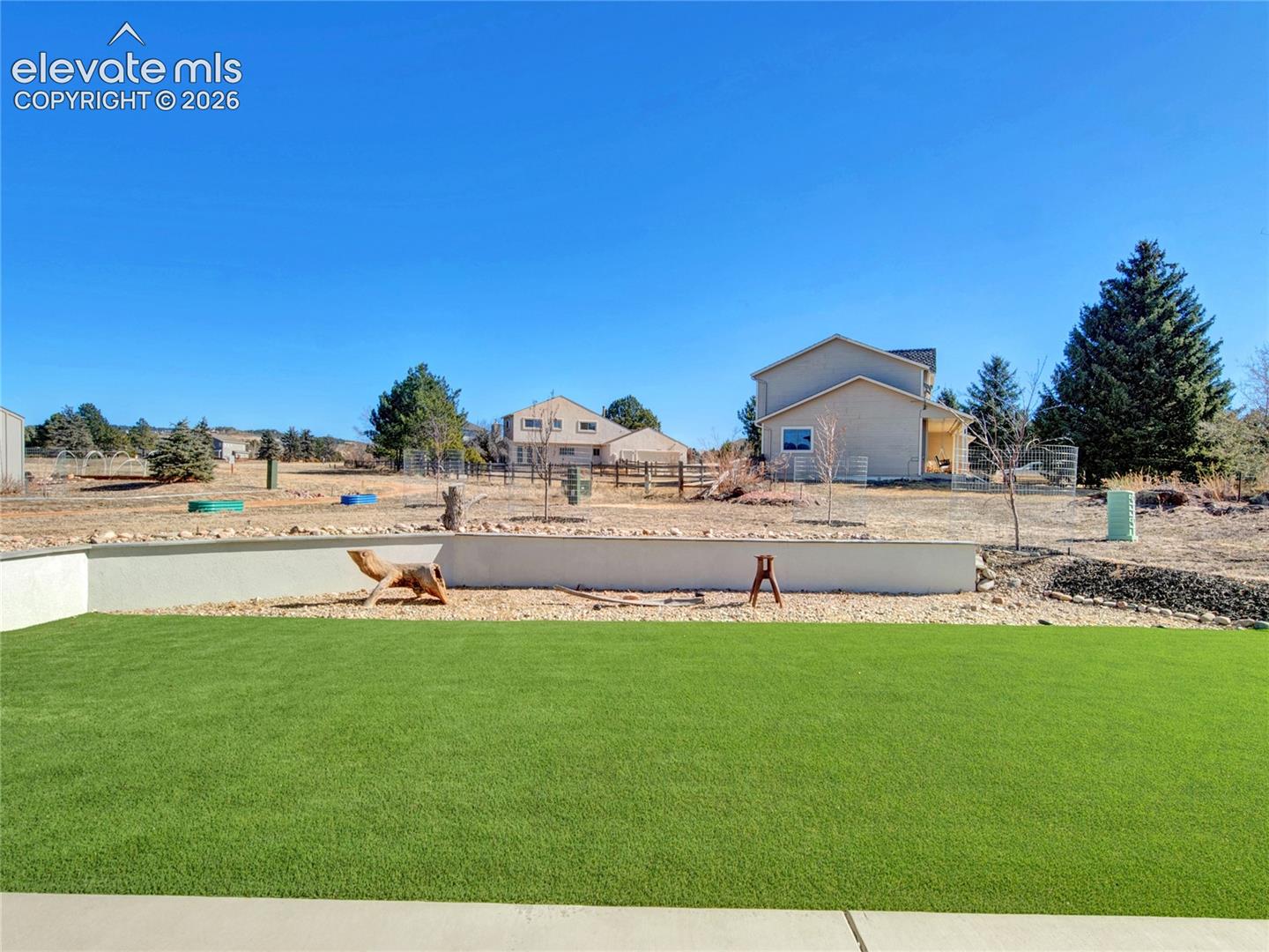 Expansive artificial turf lawn with a concrete patio