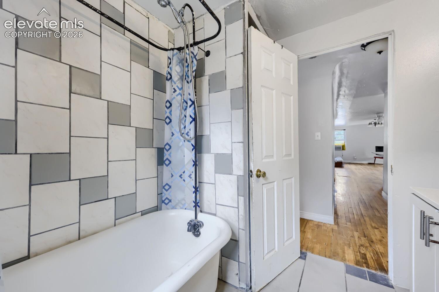 White freestanding bathtub with a shower attachment