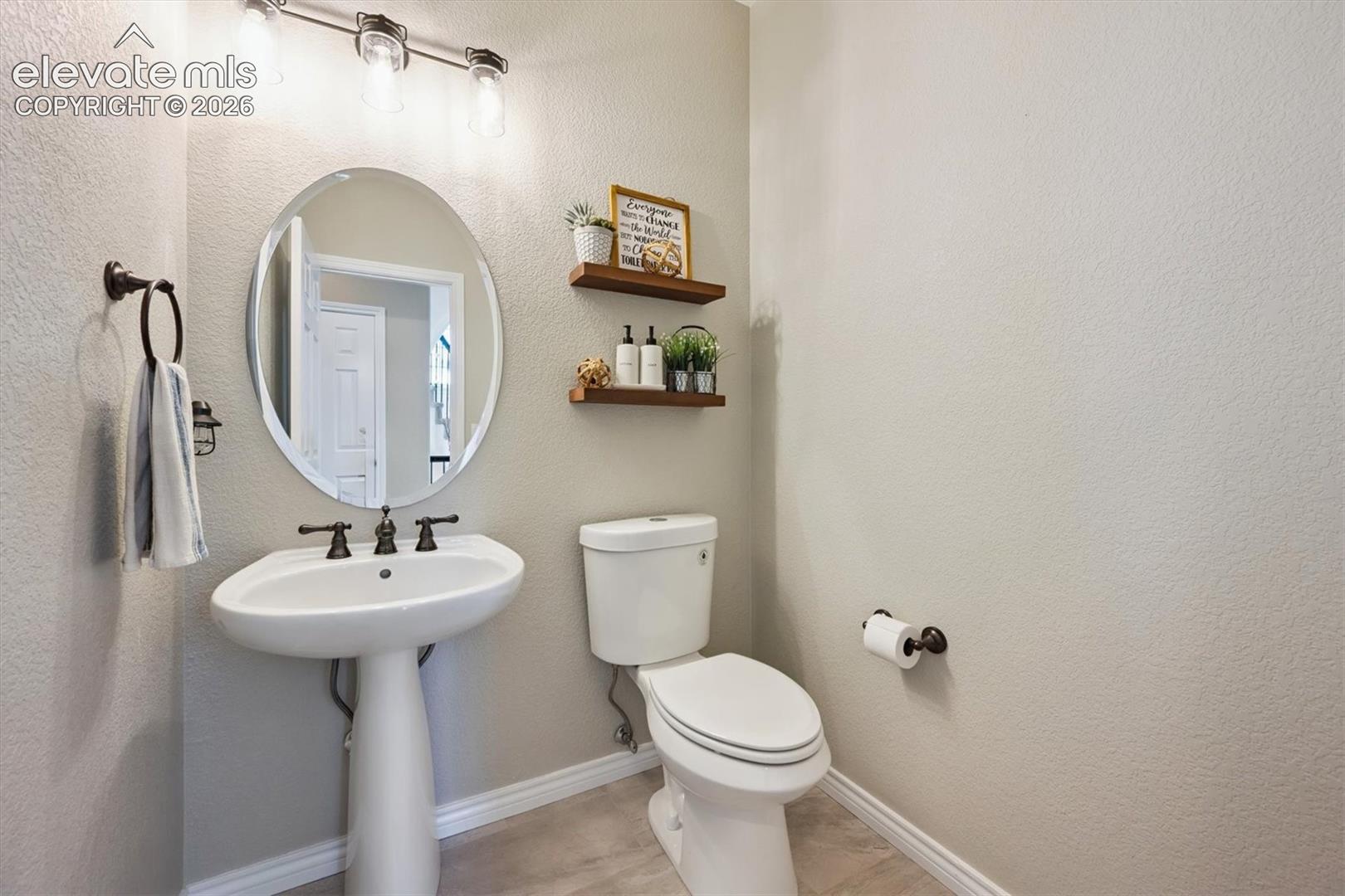 Pedestal sink with oil-rubbed bronze faucet and coordinating towel ring