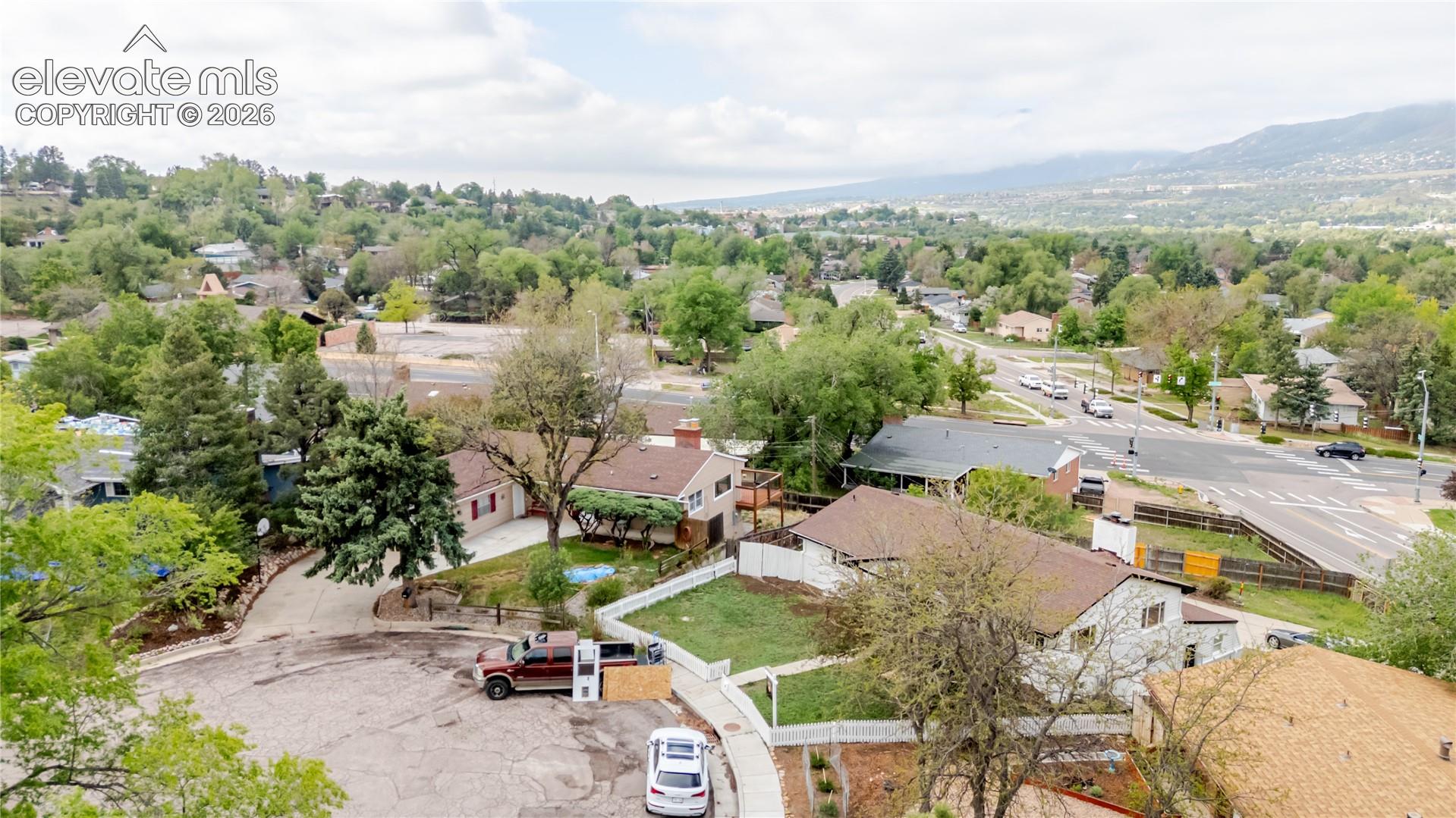 Aerial overview of a residential neighborhood with varied architecture and mature trees