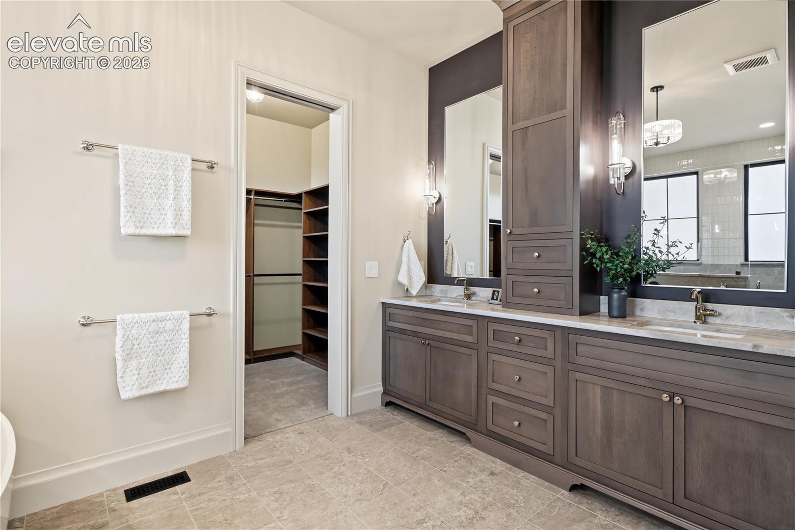 Primary bathroom with custom walk-in closet