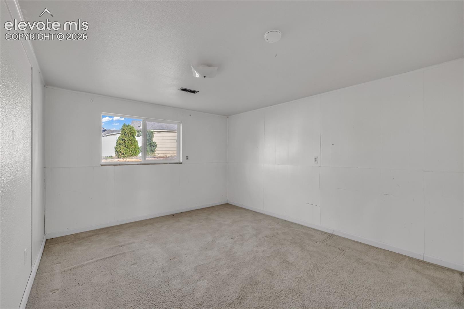 Wall-to-wall carpeting and a single window