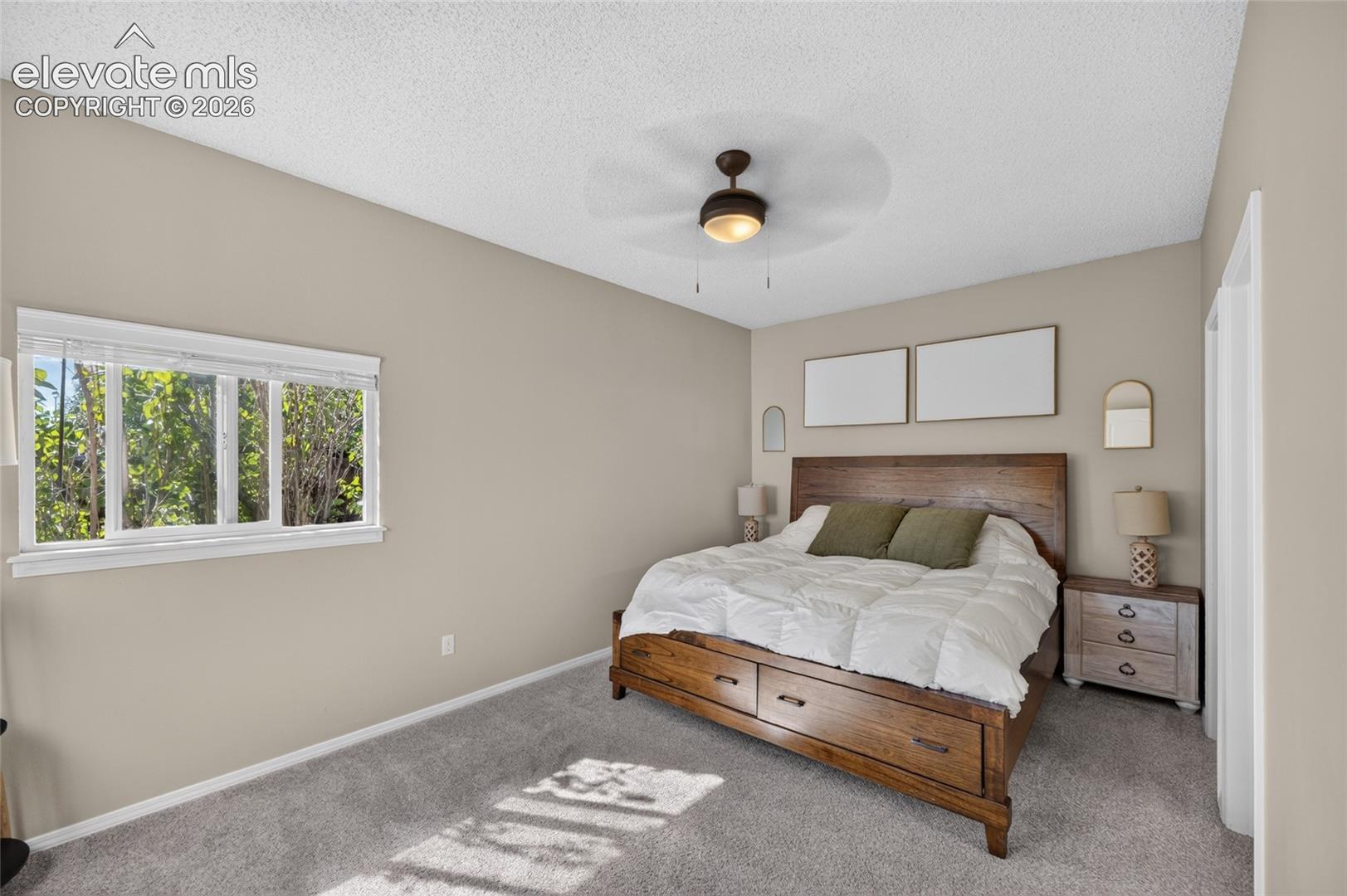 Main-level primary bedroom with new ceiling fan