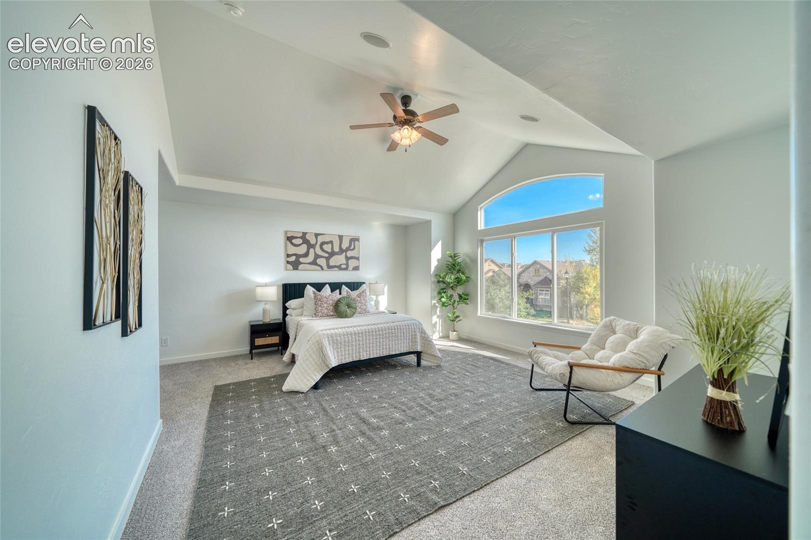 Vaulted ceilings and an arched window provide architectural interest