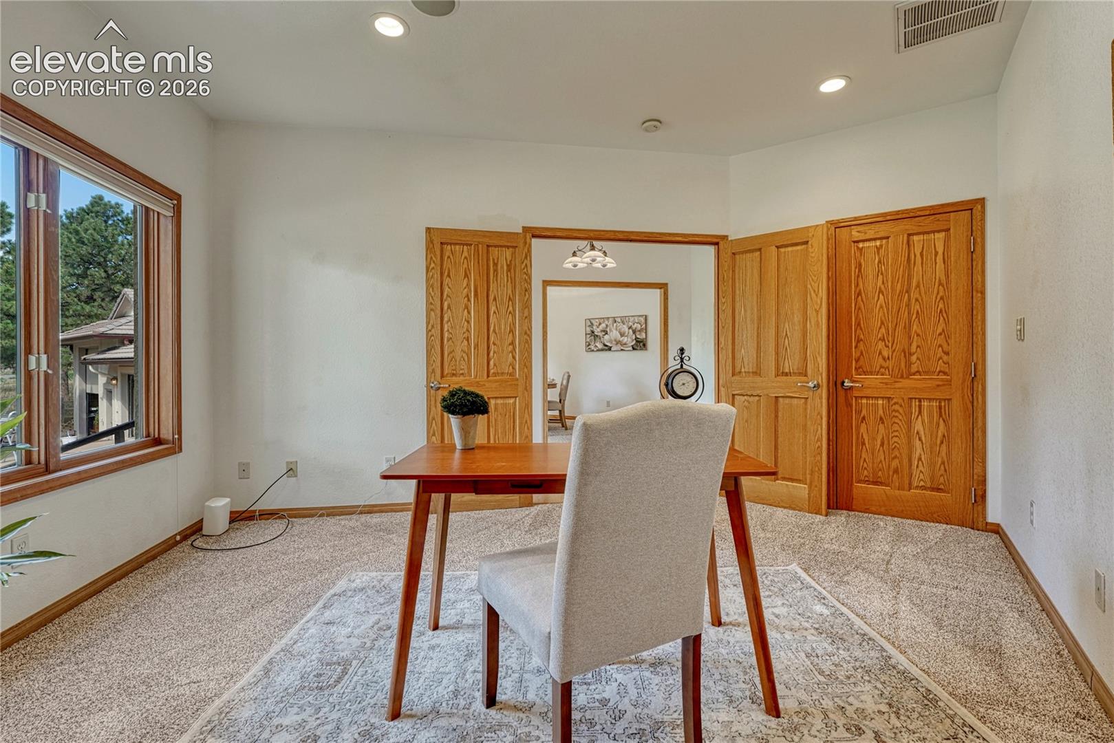 Double doors lead into the main level office with closet, recessed lighting, and in ceiling speakers.