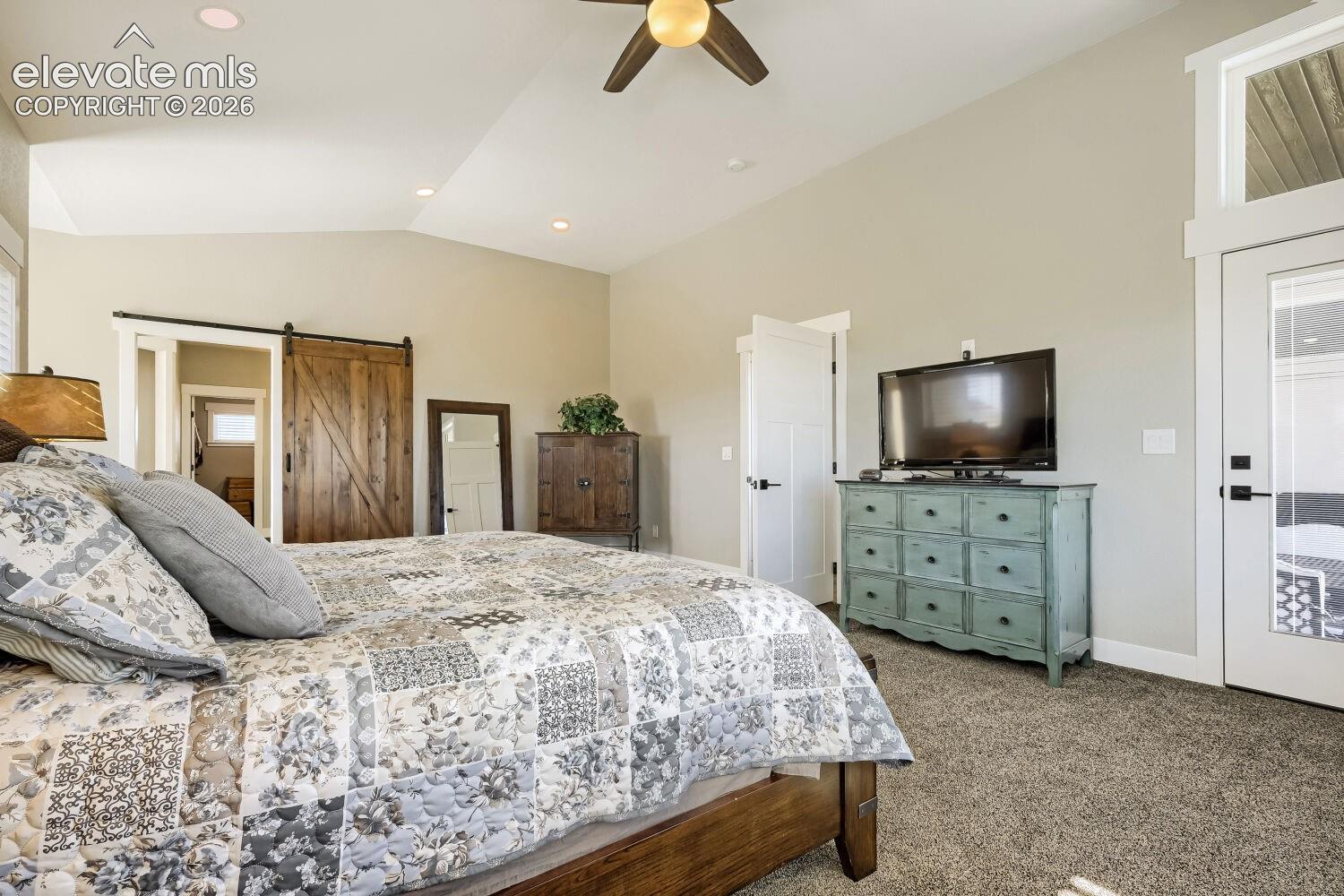Vaulted ceiling with recessed lighting and a ceiling fan