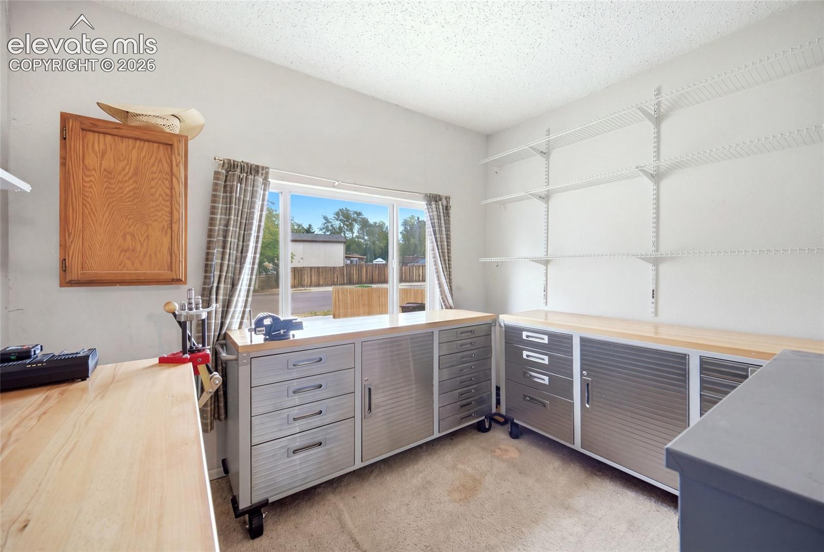 At the front of the home ( converted garage) this space is being used as a workshop.  Possibilities are endless. Hobby room, Playroom, HOme Gym etc.  