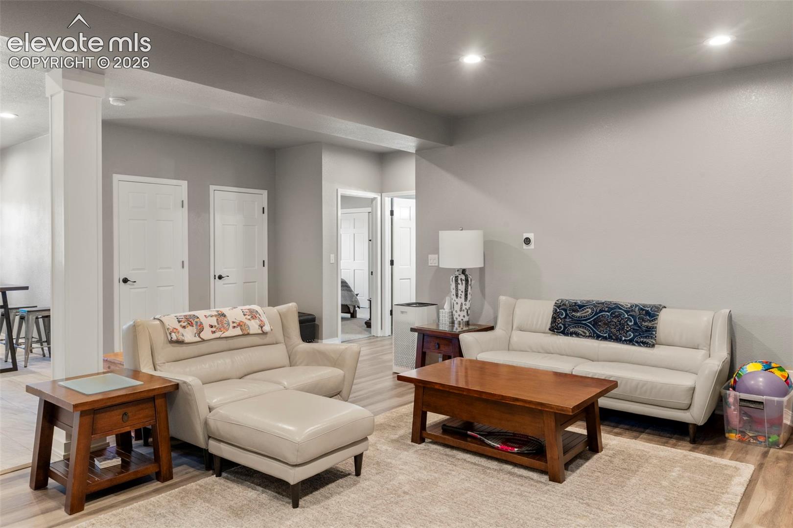 Living area with recessed lighting and light wood-style floors