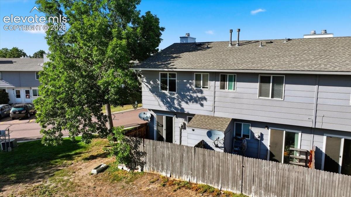 Exterior siding in a light gray finish with multiple windows