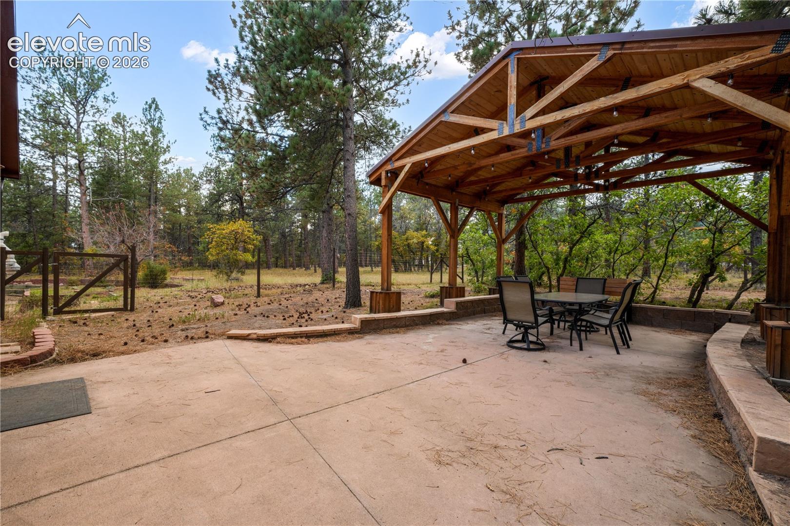 Large backyard with gazebo and fenced in area for pets