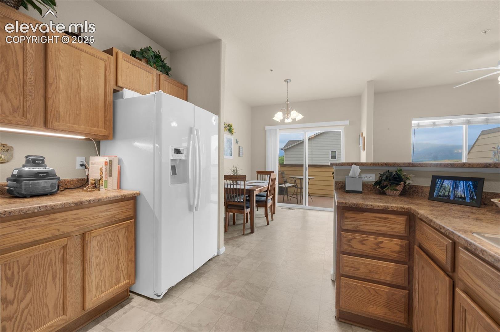 Kitchen featuring wood cabinetry with under cabinet lighting