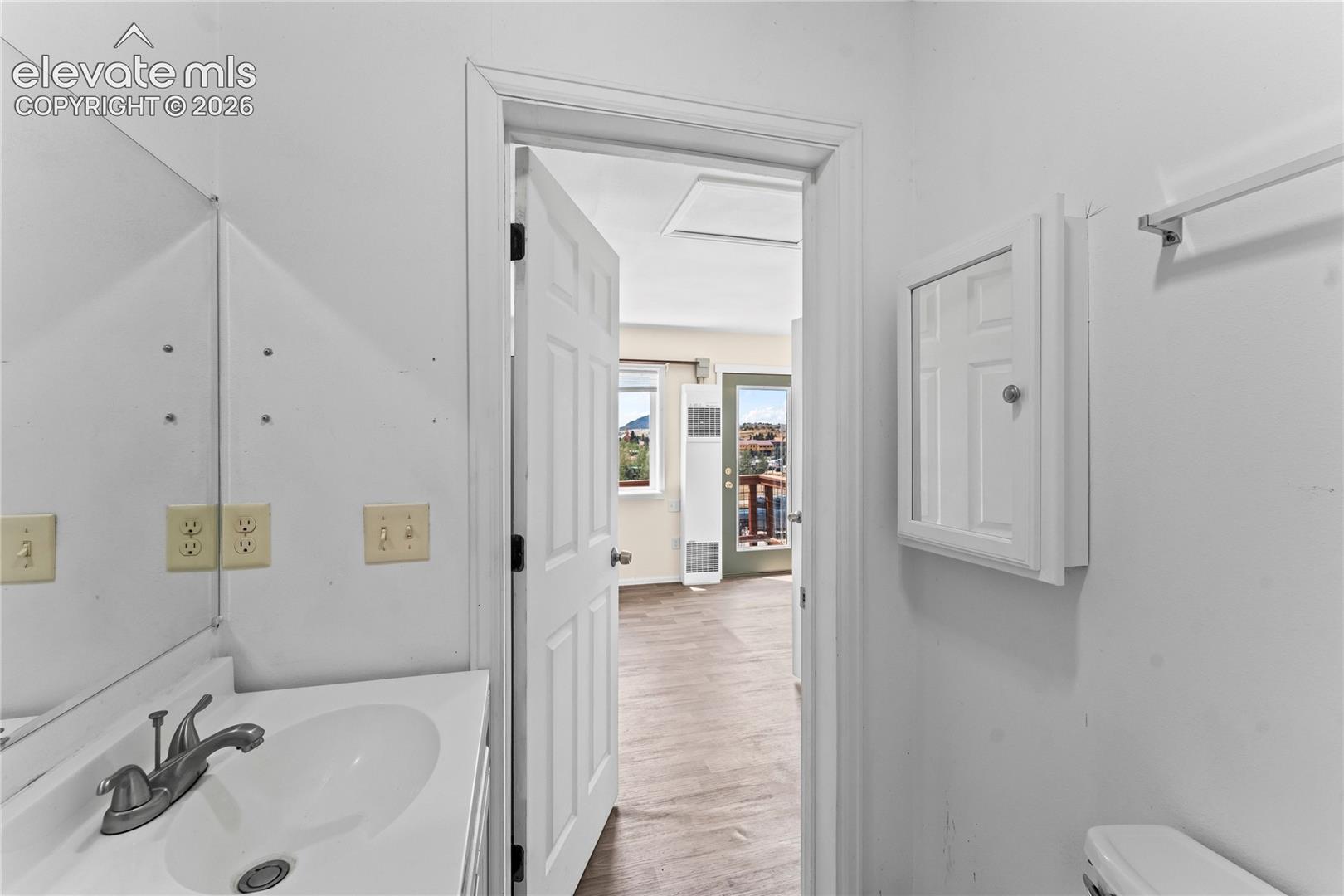 Bathroom vanity featuring an integrated sink with a chrome faucet
