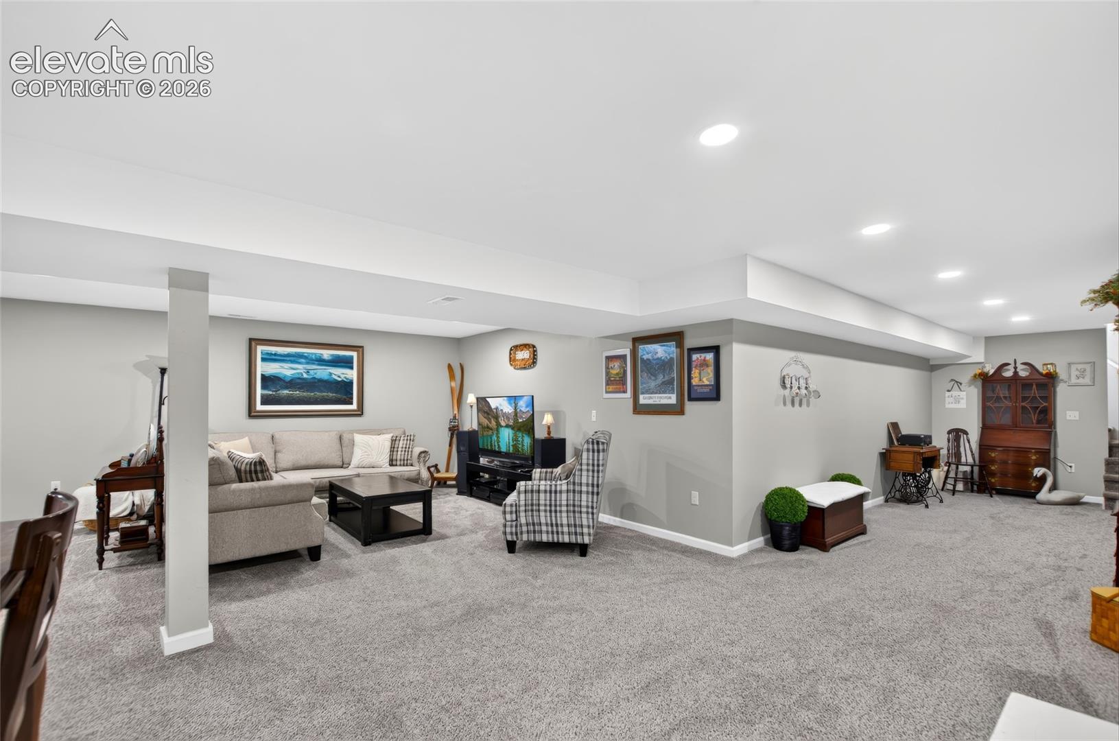 Expansive finished lower level featuring recessed lighting, a neutral gray color palette, and light gray carpeting