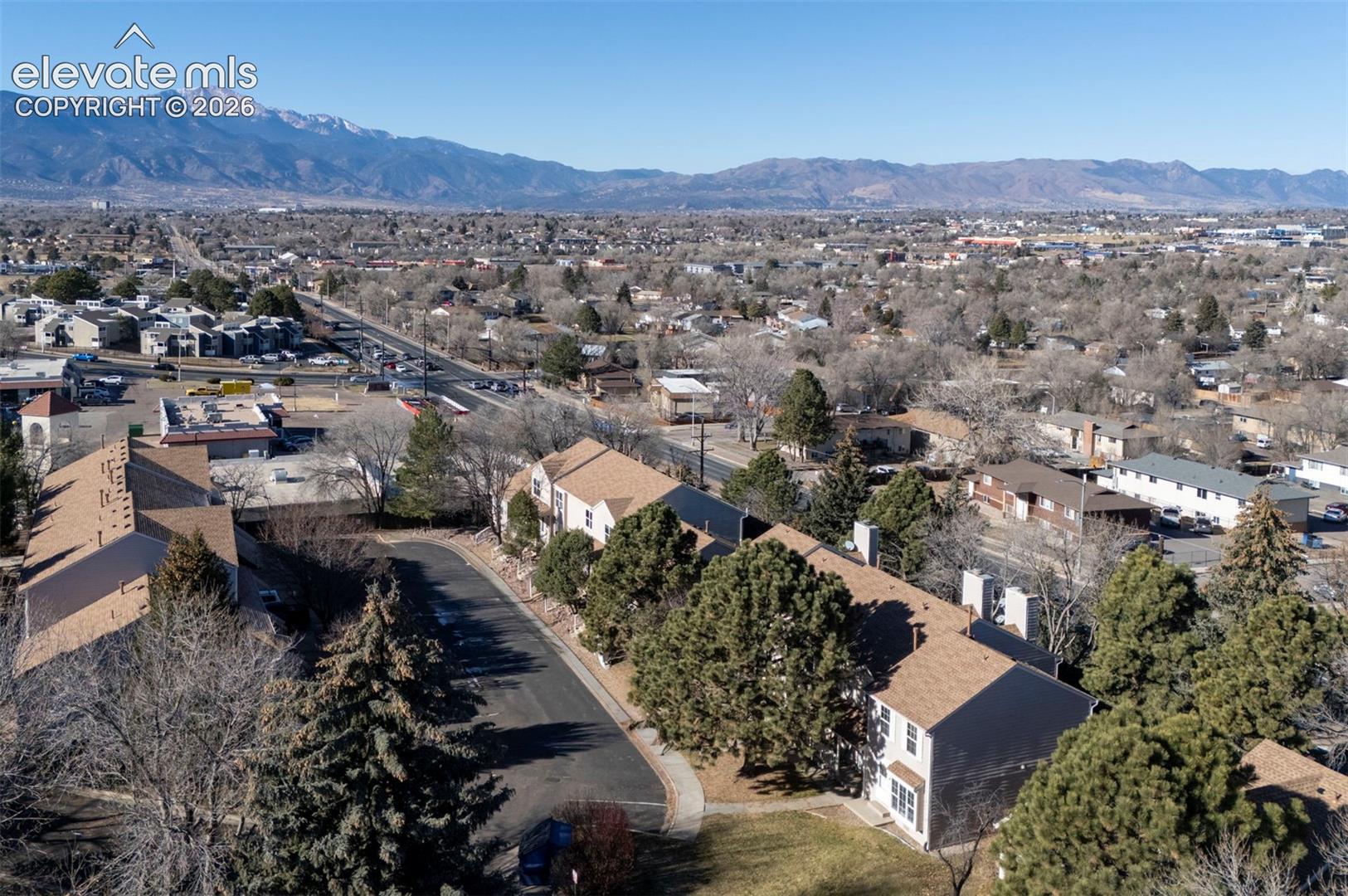 Aerial view of townhome complex and mountain views.