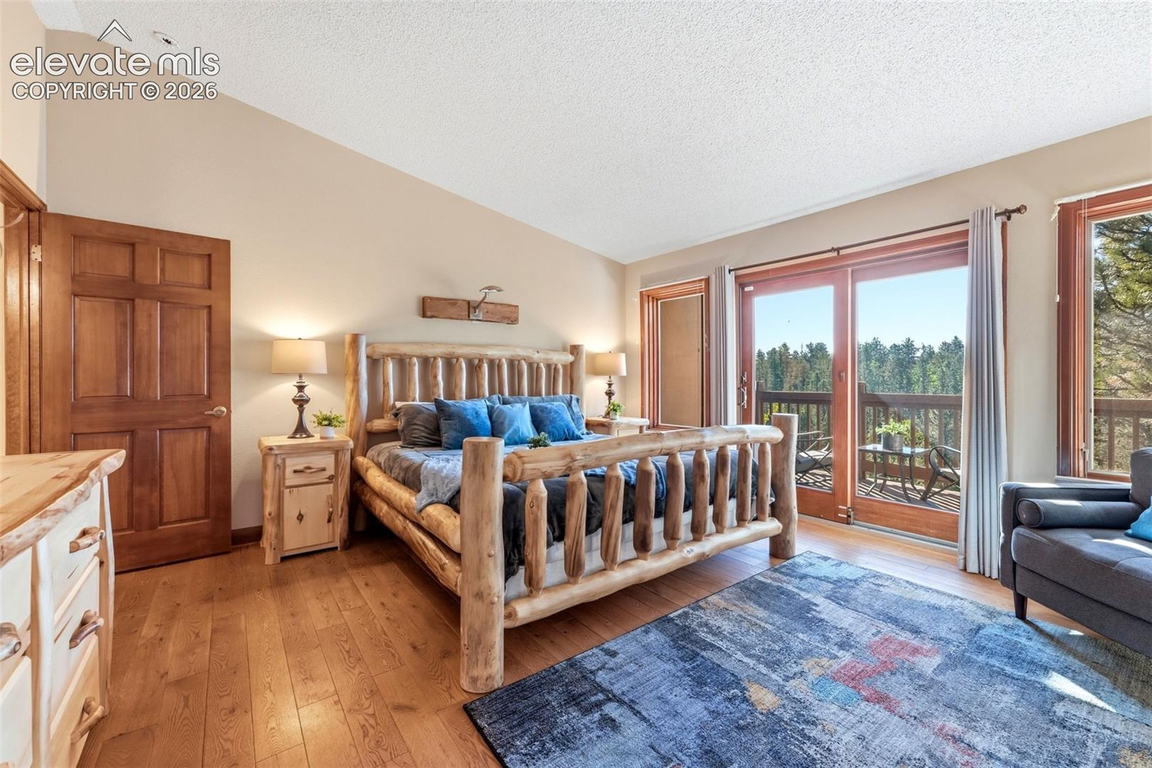 Hardwood flooring, natural wood doors, and a sliding glass door opening to a private balcony