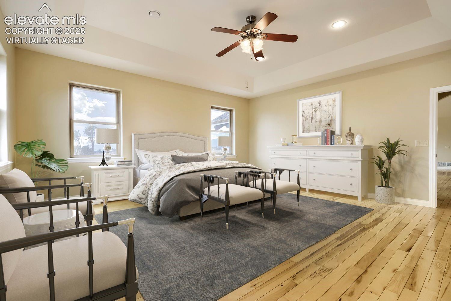 virtually staged - This spacious primary bedroom boasts stunning Pikes Peak views, a huge walk-in closet, a luxurious five piece bathroom, and a private patio perfect for enjoying Colorado's mountain scenery.