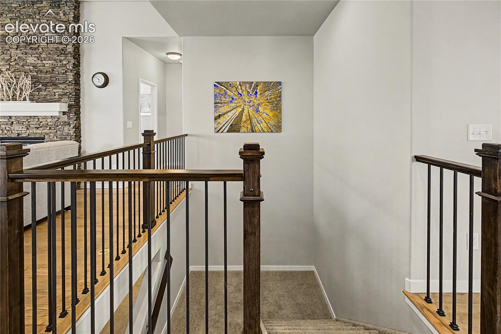 Open staircase with contemporary railings adds architectural interest and maintains the home’s bright, open feel between levels.