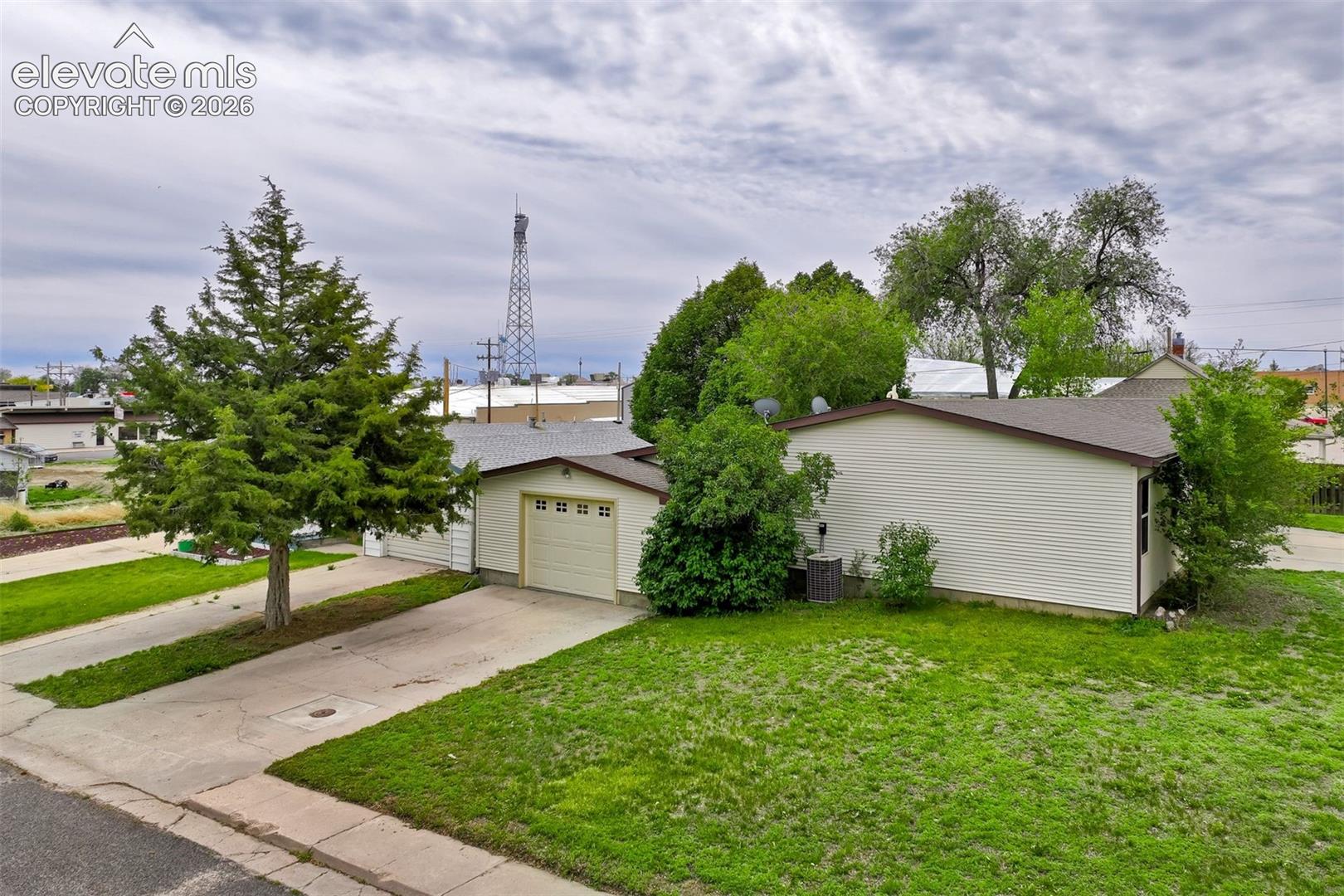 Corner lot setting provides additional yard space and an open exterior feel.