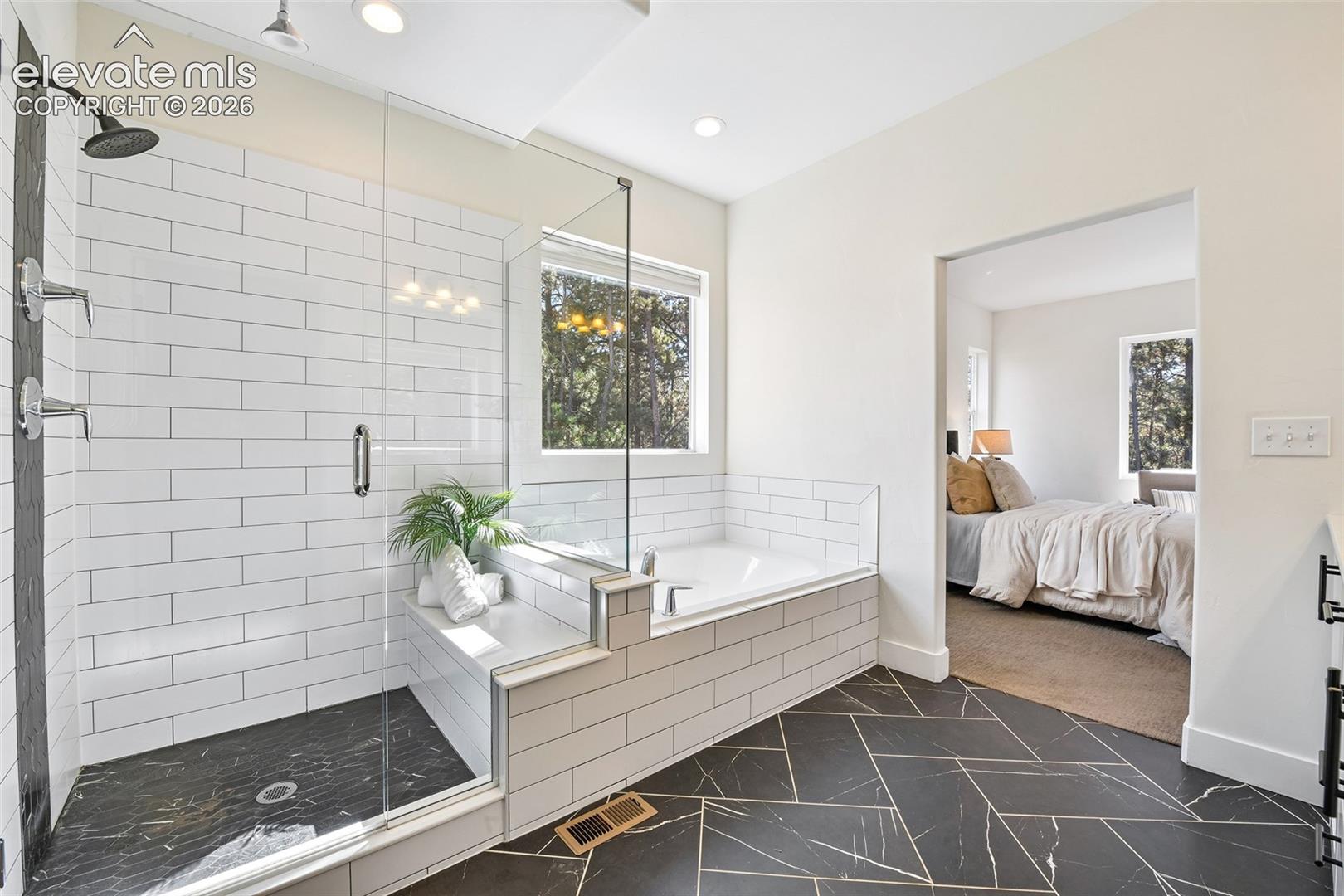 Dual shower nozzles  and bench seating in primary shower