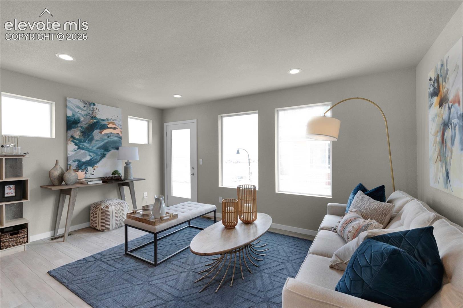 Recessed lighting, light wood-finish flooring, multiple windows, white door with clear glass, and a neutral wall color
*photos of a model home*