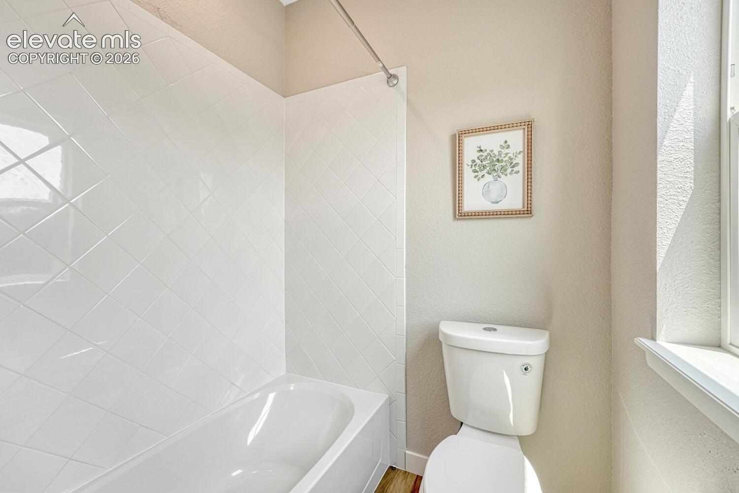 Custom tiled shower tub in the primary bathroom.