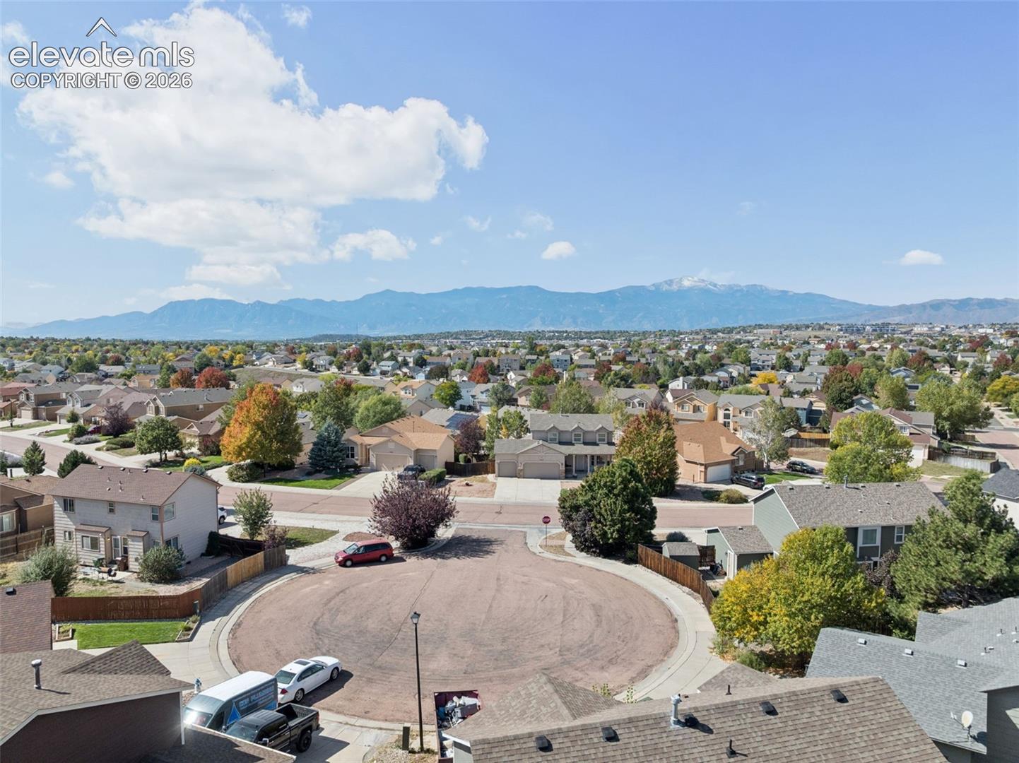 Cul-de-sac street with a mountain backdrop and a residential neighborhood