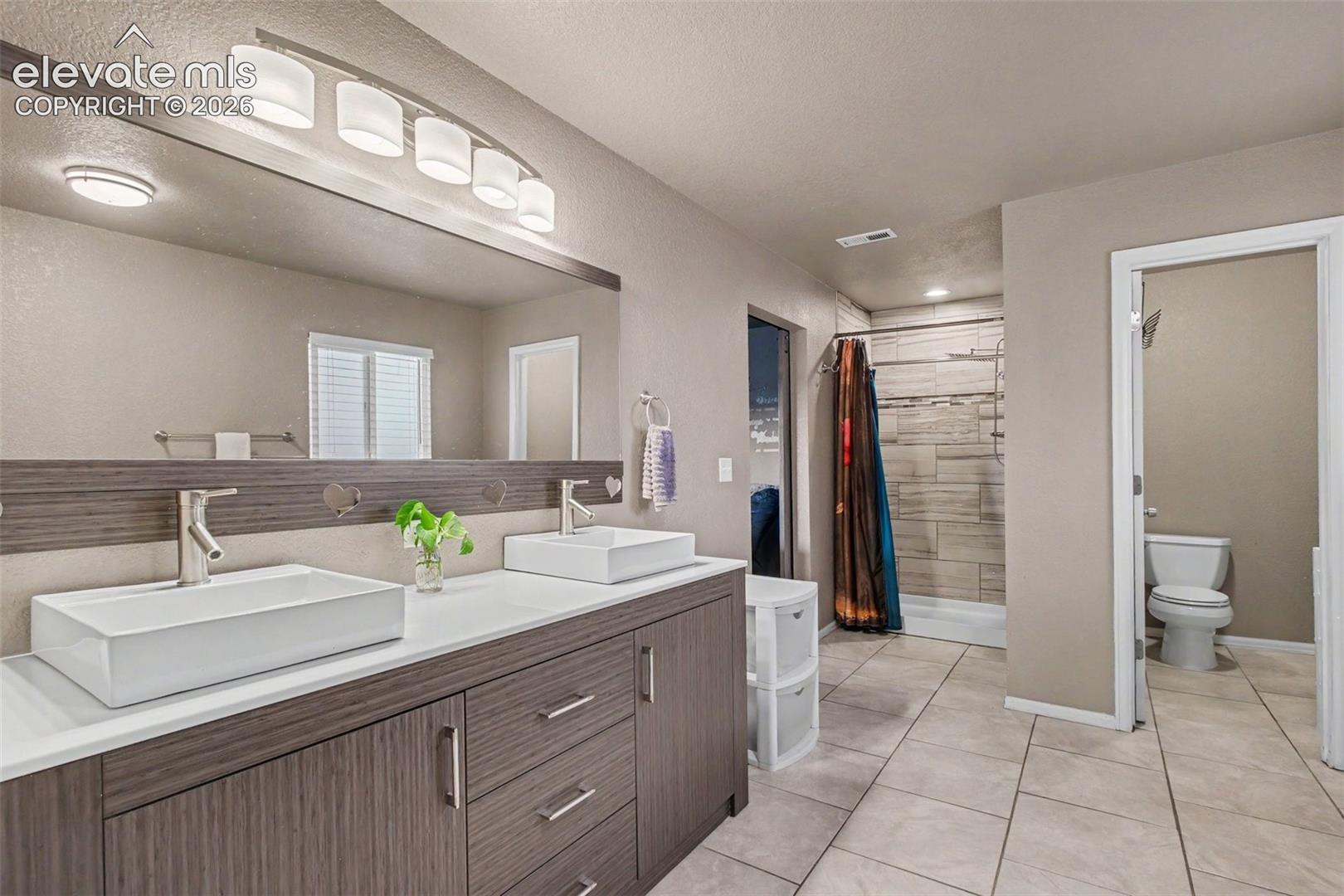 Beautifully appointed primary 5-piece  bathroom featuring dual sinks, a separate walk-in shower and a free standing tub.