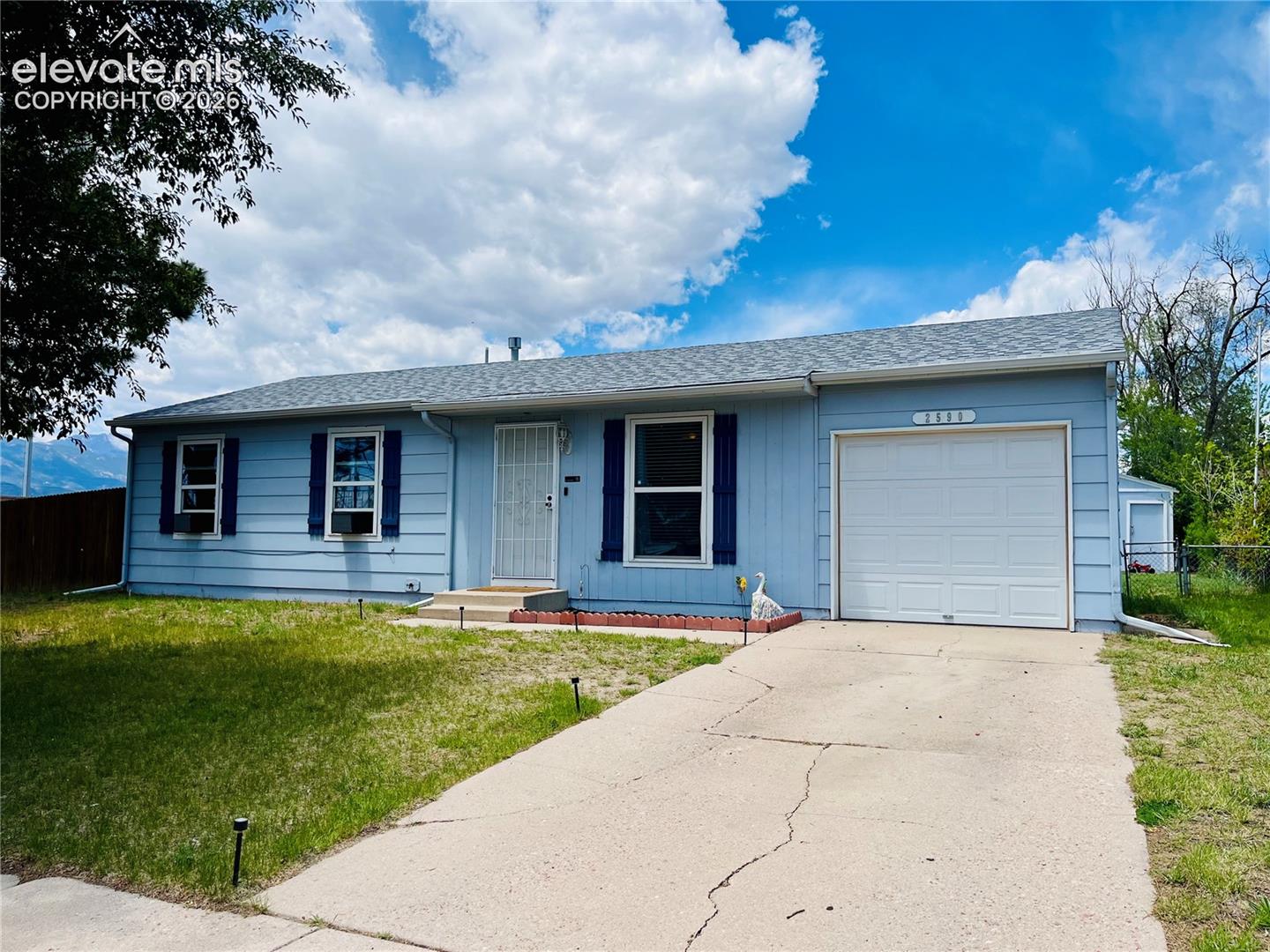 Ranch style home with attached garage and corner lot location