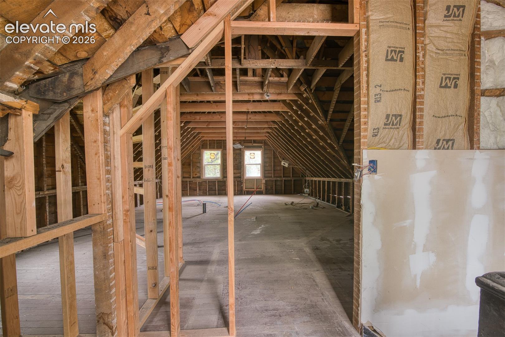 Upper level is waiting for a potential build out of a studio style apartment or large bedroom suite. 