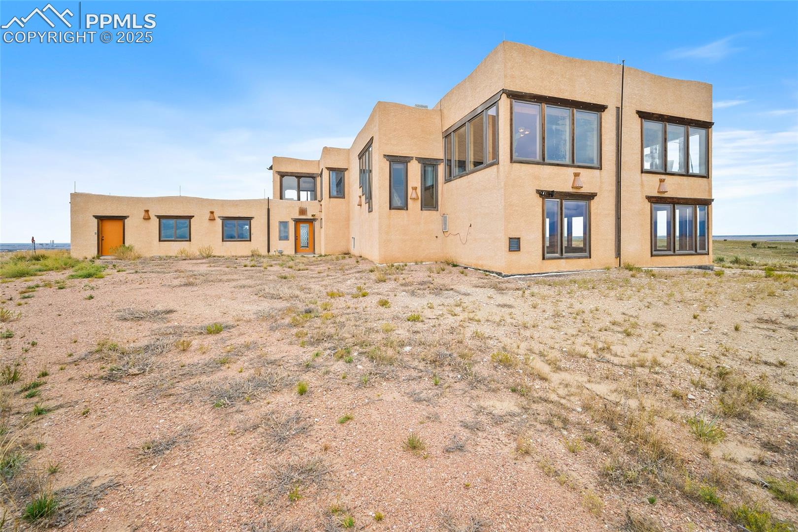 Back of house featuring stucco siding