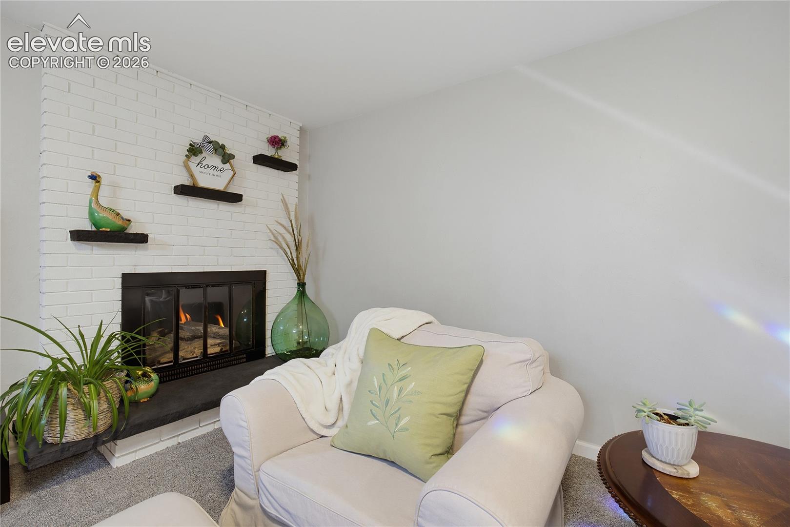 Painted brick fireplace with a dark-framed firebox and hearth