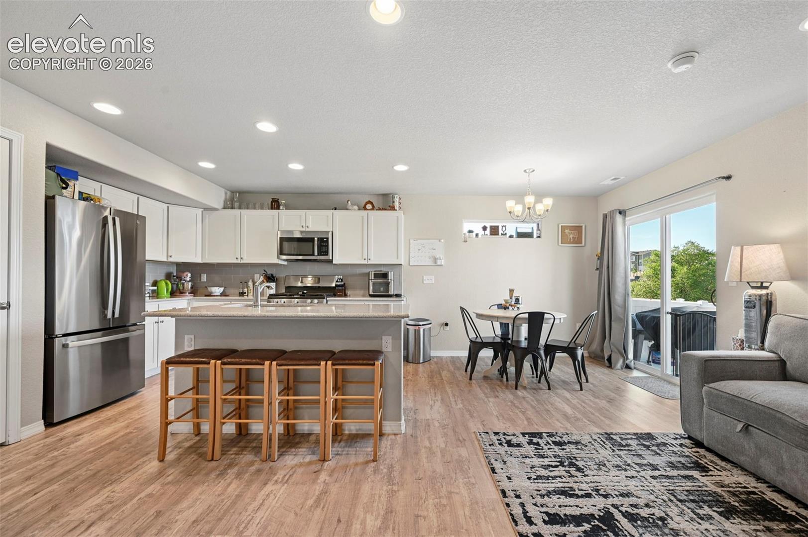 Open-concept living space with wood-finish flooring