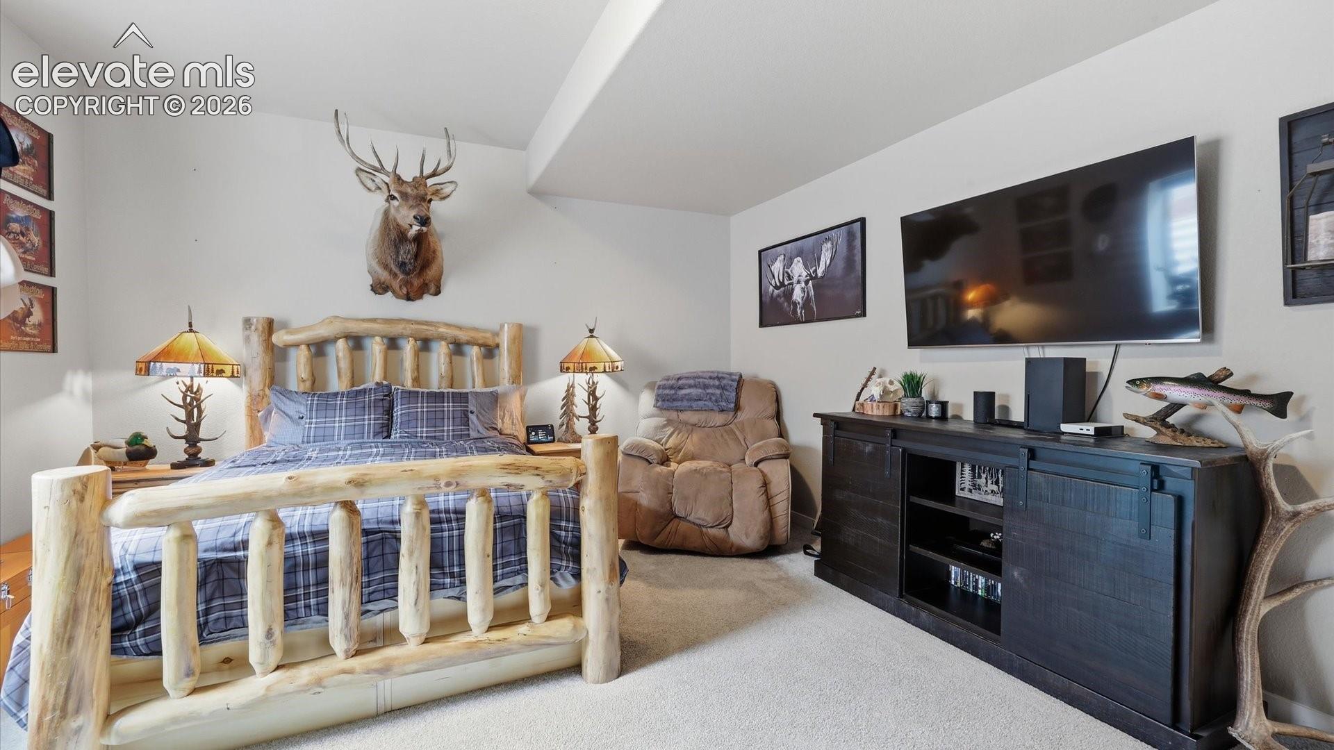 A PRIVATE LOWER-LEVEL RETREAT — A spacious and inviting bedroom with the added luxury of its own private en-suite bath, ideal for family or overnight guests.