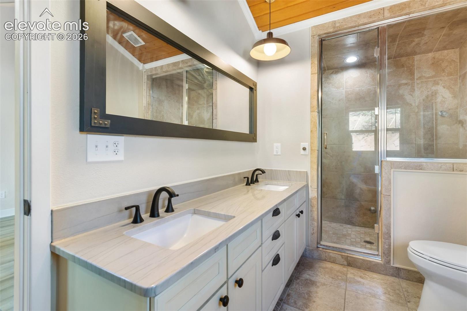 Primary bathroom with sauna shower and double sinks