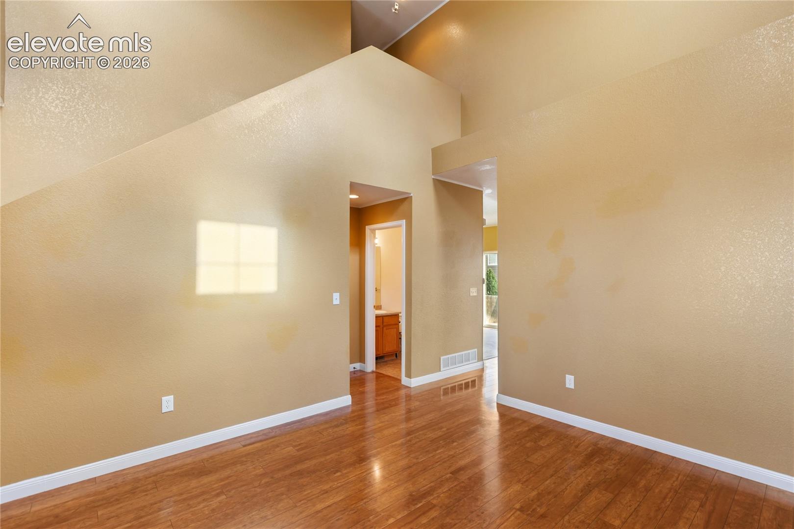 High vaulted ceilings with high windows creating a grand entrance and atmosphere. Wood lvp floors throughout add to the luxury feel.